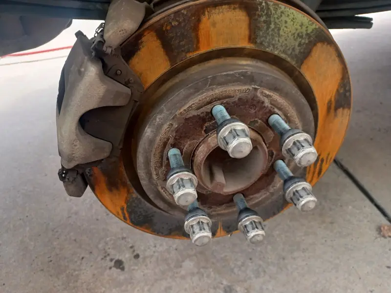 Rusted brake rotor and wheel hub before replacement