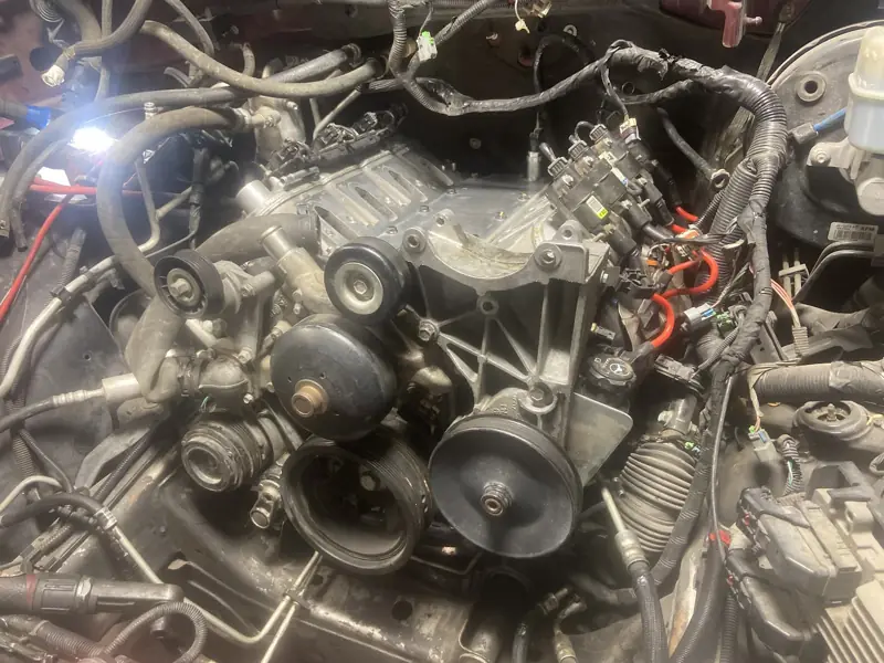 Close view of an engine bay with fuel injectors and coil packs exposed