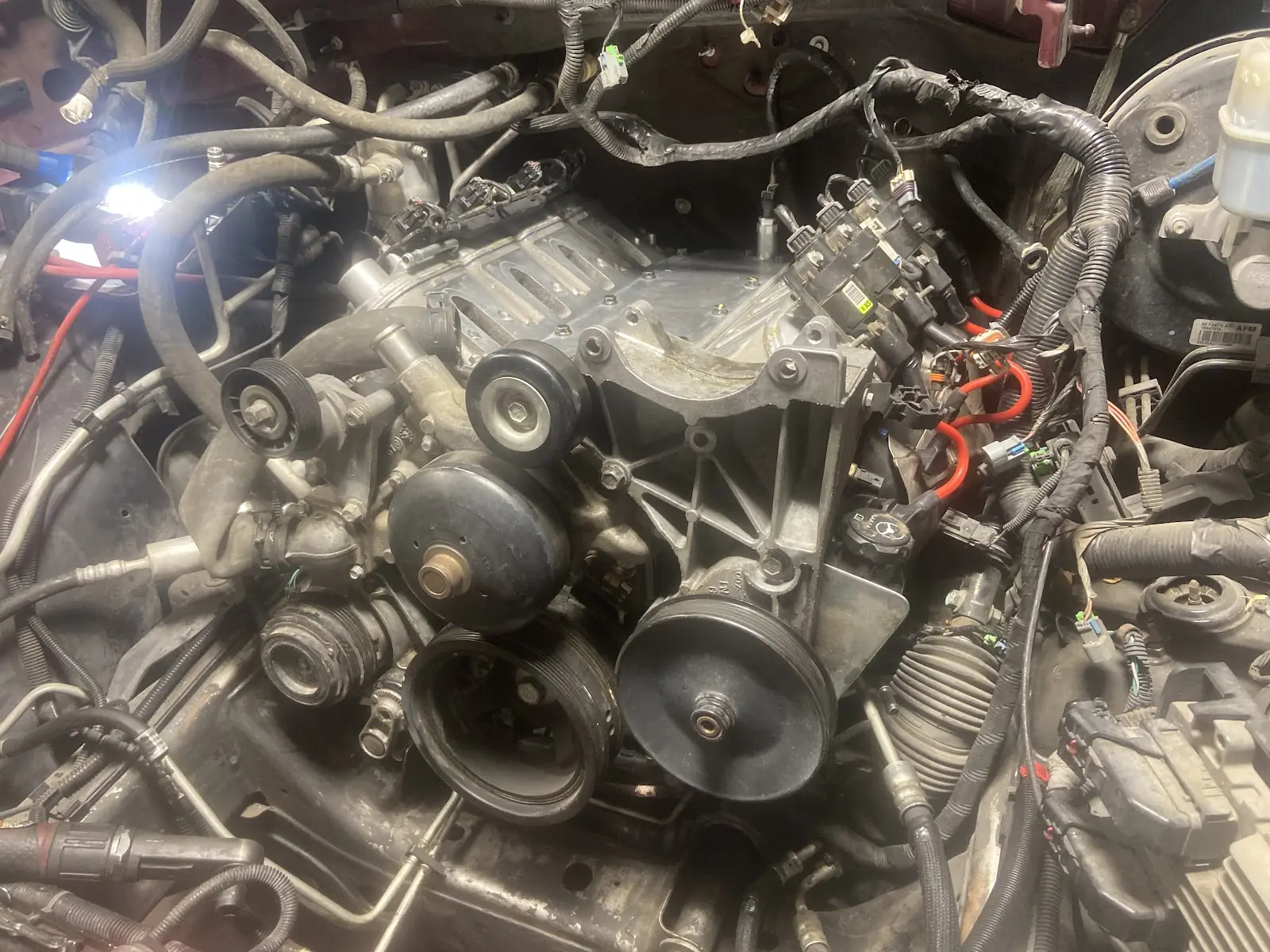 Close view of an engine bay with fuel injectors and coil packs exposed