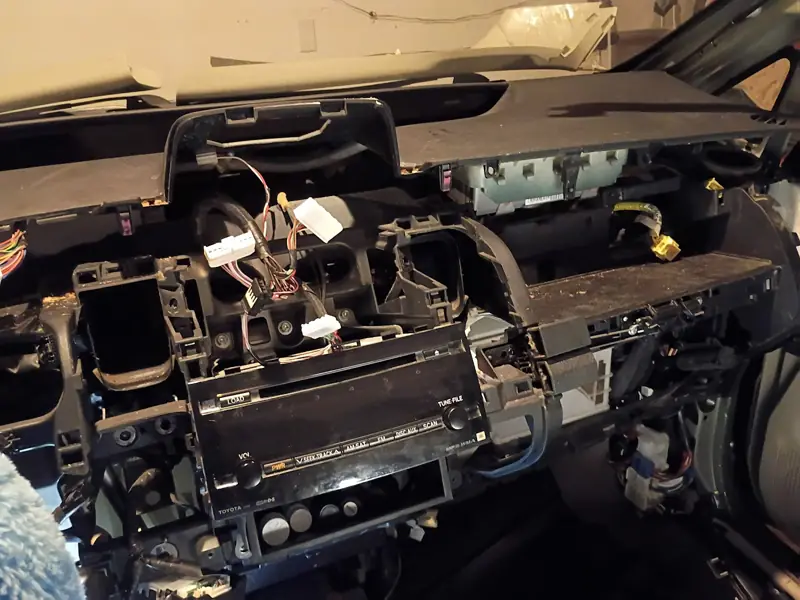 Vehicle dashboard removed exposing wiring and the HVAC housing