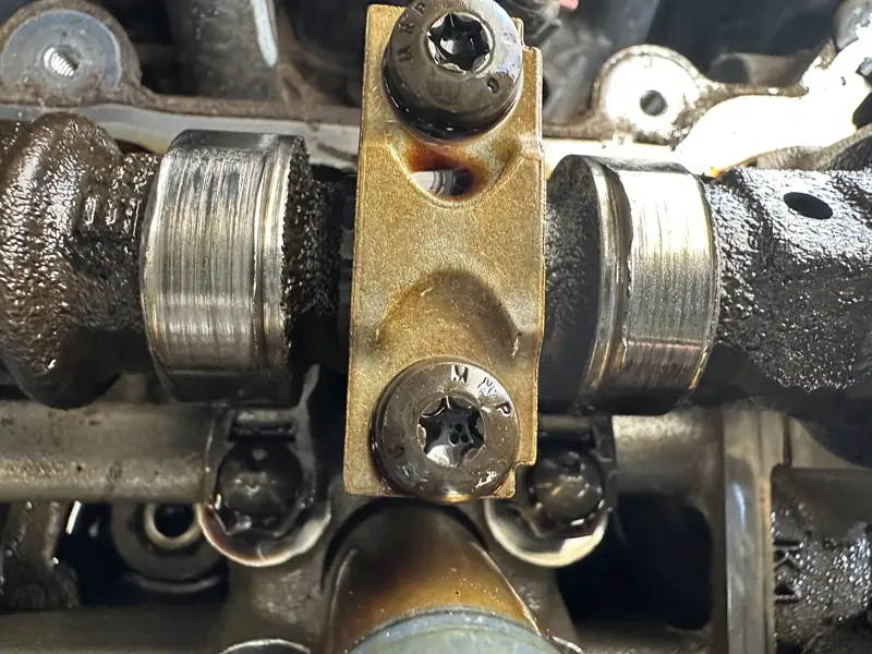 Close view of a camshaft journal cap and lifters
